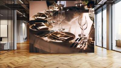 served table with white tablecloth. white plates, wine glass, fork, knife Wall mural