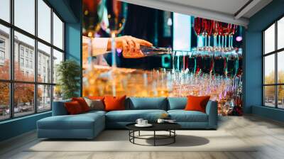 the bartender pours champagne. waiter pouring champagne at a party. Wall mural