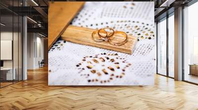 wedding rings with beautiful carvings on the sand background Wall mural