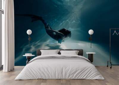 Woman with mermaid tail swims and dives underwater. Wall mural