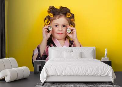 little girl in hair curlers eating sushi Wall mural