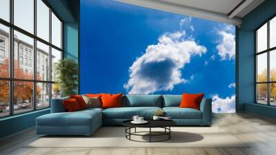 White fluffy clouds in the blue sky Wall mural