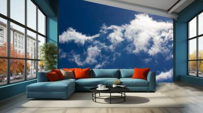 White fluffy clouds in the blue sky Wall mural