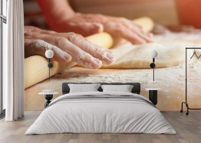 Woman rolls the dough with a rolling pin Wall mural