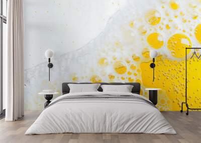 A close-up of golden yellow beer with foam and bubbles Wall mural