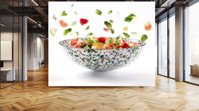 Fresh salad ingredients scattered above a bowl in a modern kitchen setting with vibrant colors and healthy vegetables Wall mural