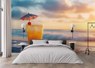 Relaxing tropical drink on the beach with sunset in the background during a peaceful evening at the shore Wall mural