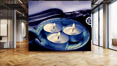 three candles with old book and magic pentagram like magical esoteric mystic atmosphere  Wall mural