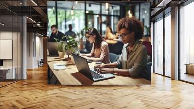 Group of Diverse Creative Team Members Using Laptops in an active Contemporary Office. Young Female Media Relations Manager Working on Brand Innovation Strategy and Collaborating with Colleagues. High Wall mural