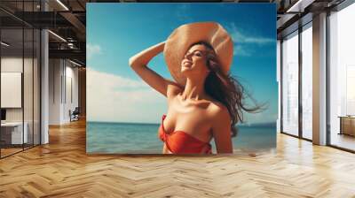 Portrait of a happy brunette with a hat in a swimsuit on a tropical beach. Summer vacation and good vibes concept. High quality photo Wall mural