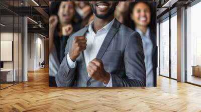 Portrait of young smiling African American businessman standing confidently in front of the team cheering. Leadership concept. High quality photo Wall mural