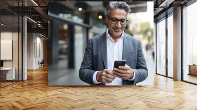 Smiling mature Latin or Indian businessman holding the phone. High quality photo Wall mural