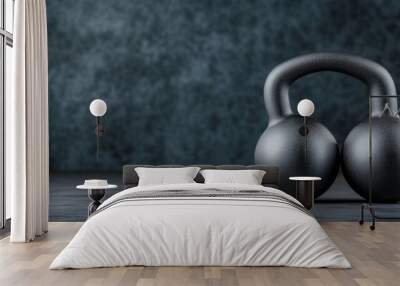 A pair of kettle bells sitting on a table against a gray background, AI Wall mural