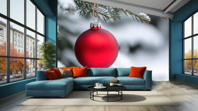 A red christmas ornament hanging from a tree branch in the snow, AI Wall mural