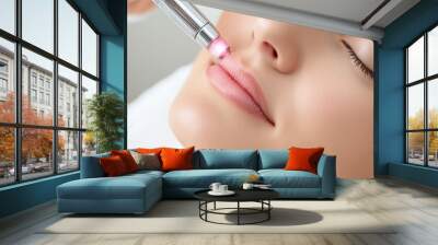 A woman getting a facial with an electric device on her face, AI Wall mural