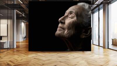 An old woman with her eyes closed and a black background, AI Wall mural