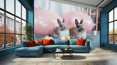 Two bunnies sitting on a blue cushion with balloons in the background. AI generative image. Wall mural