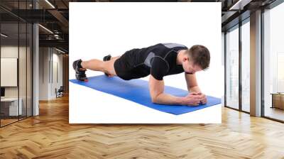 Young man doing Elbow Plank Workout Wall mural