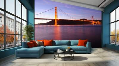 Glowing Golden Gate Bridge at sunset. Shot from Fort Point area. Wall mural