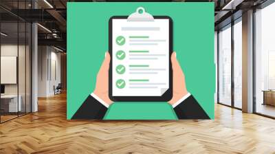 Hand holding clipboard with checklist in a flat design. Vector illustration Wall mural