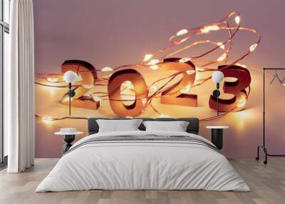 Garland. Christmas lights. Christmas, winter, new year concept. Merry Christmas and Happy New Year. Holiday. Happy New Year 2023 poster. Christmas background with big golden numbers 2023. Wall mural