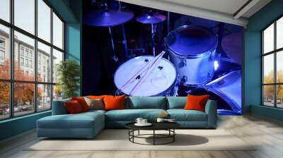 Set of drums. Detail of a drum kit closeup. The concept of a live concert. Drum set on rock concert stage. Professional musical instruments for drummer musician. Drumming instrument on rock festival. Wall mural