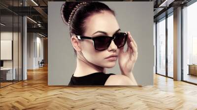 close-up of beautiful brunette model in stylish sunglasses Wall mural