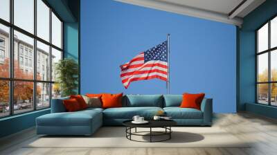 American Flag . USA national flag waving on wind against blue sky. Slow motion Wall mural