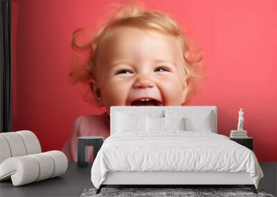 a smiling baby is looking at camera and laughing Wall mural