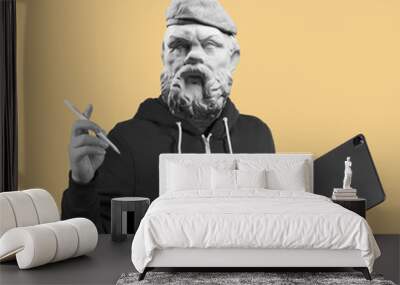 Modern art collage. Concept portrait man holding tablet and pencil. Gypsum head of Socrates. Wall mural