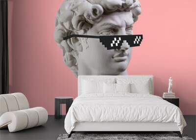 Statue. Earphone. Isolated. Gypsum statue of David's head. Man. Creative. Plaster statue of David's head in pixel glasses. Minimal concept art. Wall mural