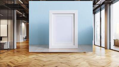 blank white picture frame on the table wood with blue background Wall mural