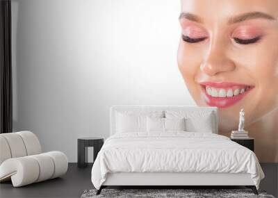 Closeup shot of beautiful female smile, white background. Wall mural