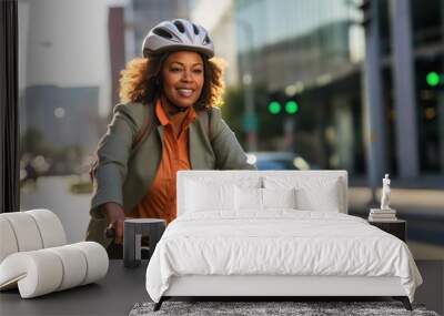 Cycling commuter - a middle aged beautiful African American woman riding a bicycle on a road in a city street Wall mural