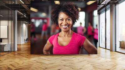 Diverse collection of people of different cultures and ages exercising in a fitness studio. Smiling women from different cultural backgrounds come to work out at the fitness studio, showing diversity. Wall mural