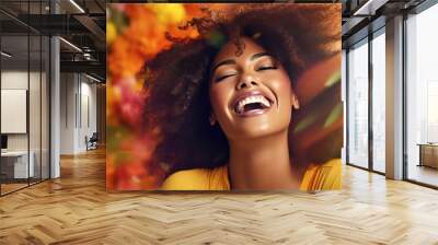 Happy laughing African American young woman on a yellow autumn background. Photo with autumn mood. Wall mural