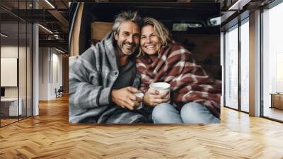 Mature couple in love in a motorhome. They chat and drink morning coffee. Traveling as a couple away from the hustle and bustle of the big city and be alone. Wall mural