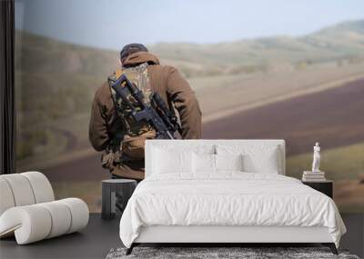 Military man with sniper rifle SVD, view from the back. Wall mural