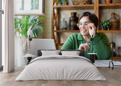 Modern technology concept in everyday life - a smiley senior woman in front of laptop monitor during online video call. Wall mural