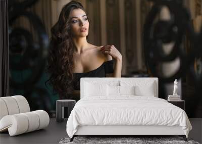 The image of a beautiful luxurious woman sitting on a vintage couch Wall mural