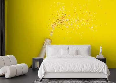 Champagne with party concept, Champagne bottle with confetti colorful stars on yellow background Wall mural