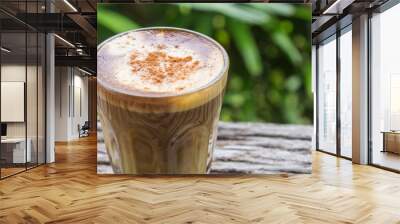 Latte Coffee in Glass on Wood Table with Natural Tree Background Zoom Wall mural