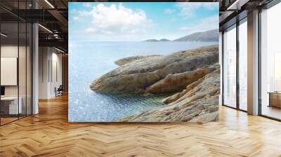 Stones, nature and ocean by beach with blue sky, waves and coastline for outdoor travel destination. Seascape, water and sea by rocks on tropical island for summer holiday, vacation or trip. Wall mural