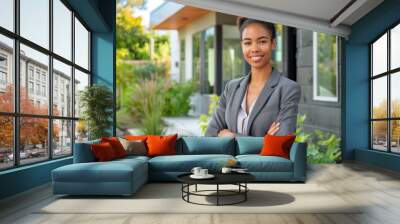 Confident real estate agent, mixed raced beautiful woman stands proudly outside a modern home.  Wall mural