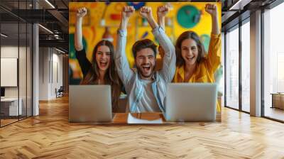 Diverse business team employees celebrating good news with their fists up in the air. Business win, corporate success Wall mural