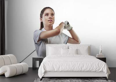 Going for distance and accuracy. Studio shot of a young golfer practicing her swing isolated on white. Wall mural