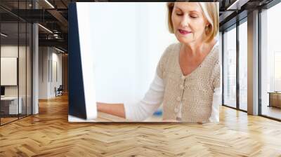 Mature woman at desk with computer, paperwork and administration for business accounting. Report, review and senior businesswoman reading invoice documents for finance, budget and office management Wall mural