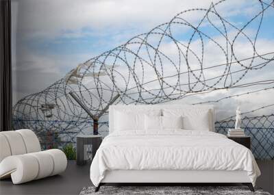 Barbed wire fence. Razor wire. Restricted area. Airport protection. Wall mural