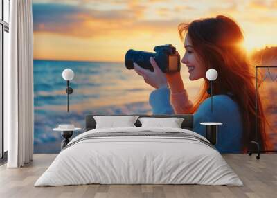 Happy woman female photographer on a summer vacation by the sea, holding camera photographing beautiful ocean views and landscapes lifestyle of adventure and freedom while taking photos during journey Wall mural