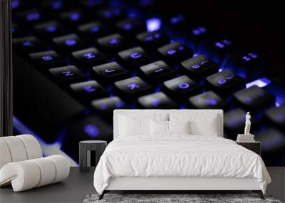 Letters on a blue illuminated blue keyboard in dark close up Wall mural